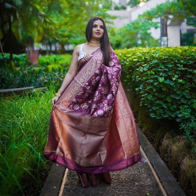 Beautiful wine floral patterned Banarasi soft silk saree elegantly displayed