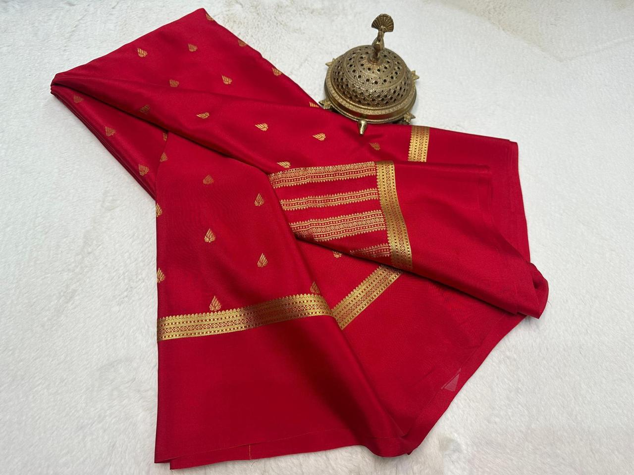 Red saree with gold patterns on a white background