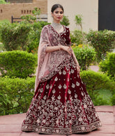 Red colored designer partywear embroidered work velvet material lehenga choli dc 202