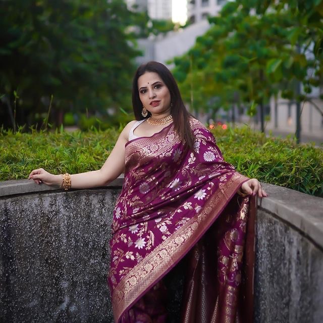 Fashionable wine floral printed Banarasi soft silk saree hanging on a rack