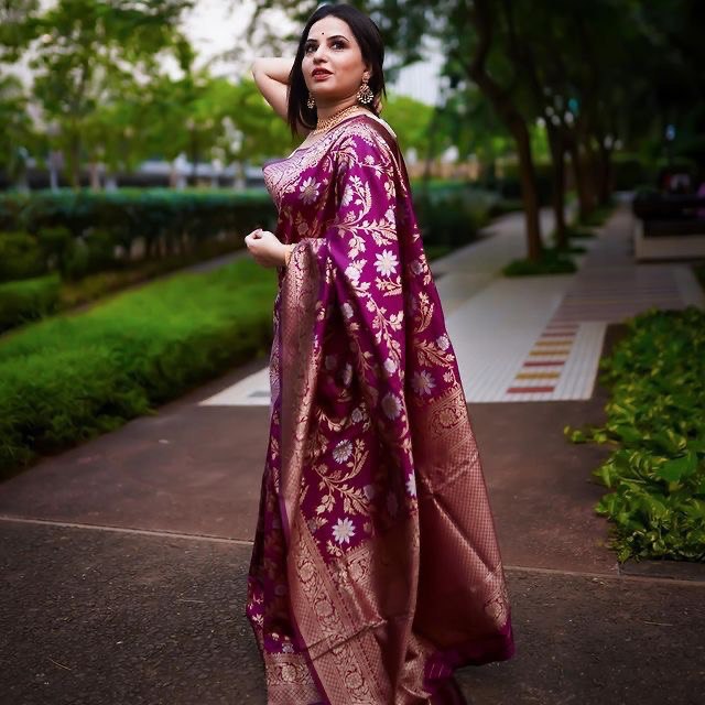 Stylish Banarasi soft silk saree with wine floral motifs laid out gracefully